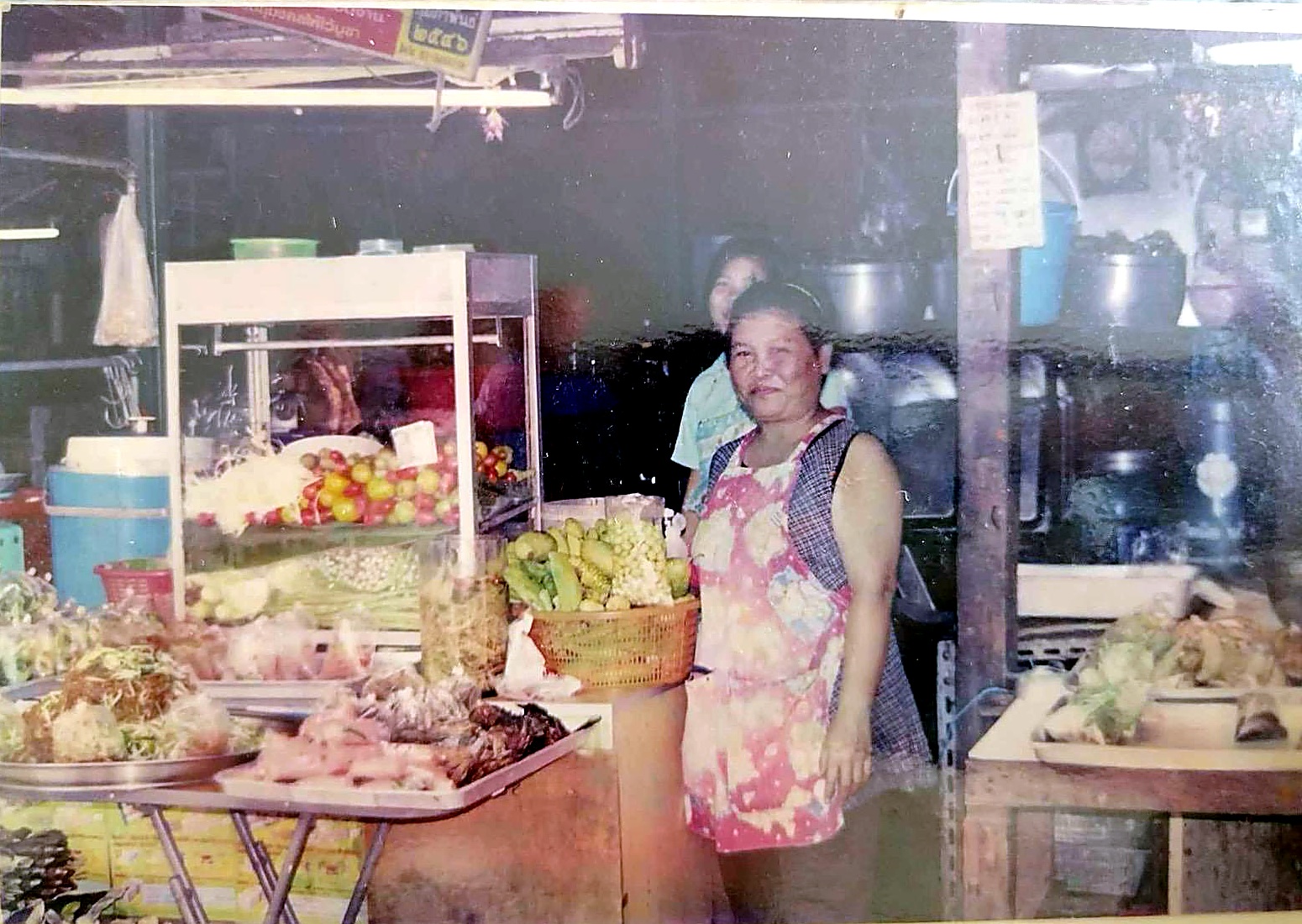 The owner as a child at her mother's market stall in Thailand